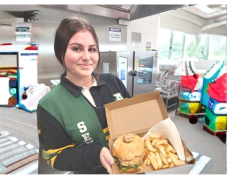 Student in the kitchen with a meal they prepared