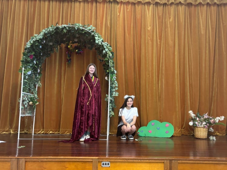 Students in costume on stage